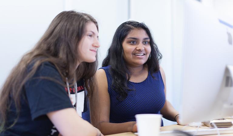 Two students sitting at a computer.